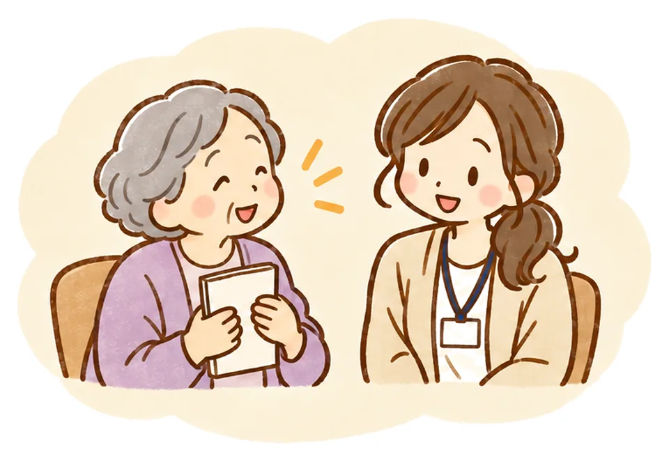 ノートを胸に抱えたおばあさんが静かに話し、ケアマネがうなずいて聞いている