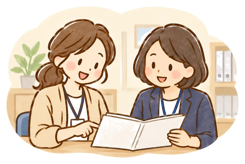 相談室でケアマネが相談員と資料を見ながら相談している