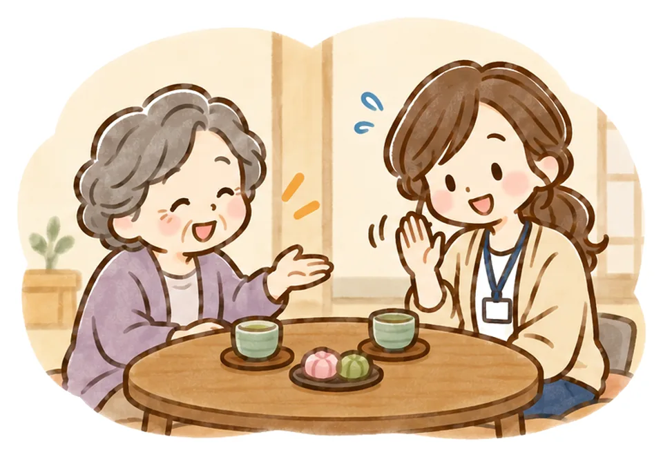 お茶とお菓子をすすめるおばあさんに、ケアマネが恐縮して手を振っている